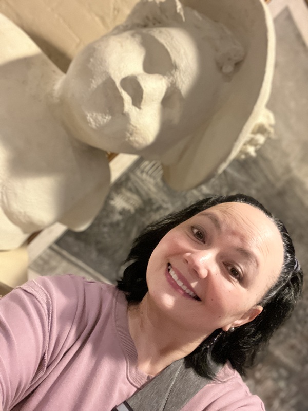Susan Smith posing with a statue